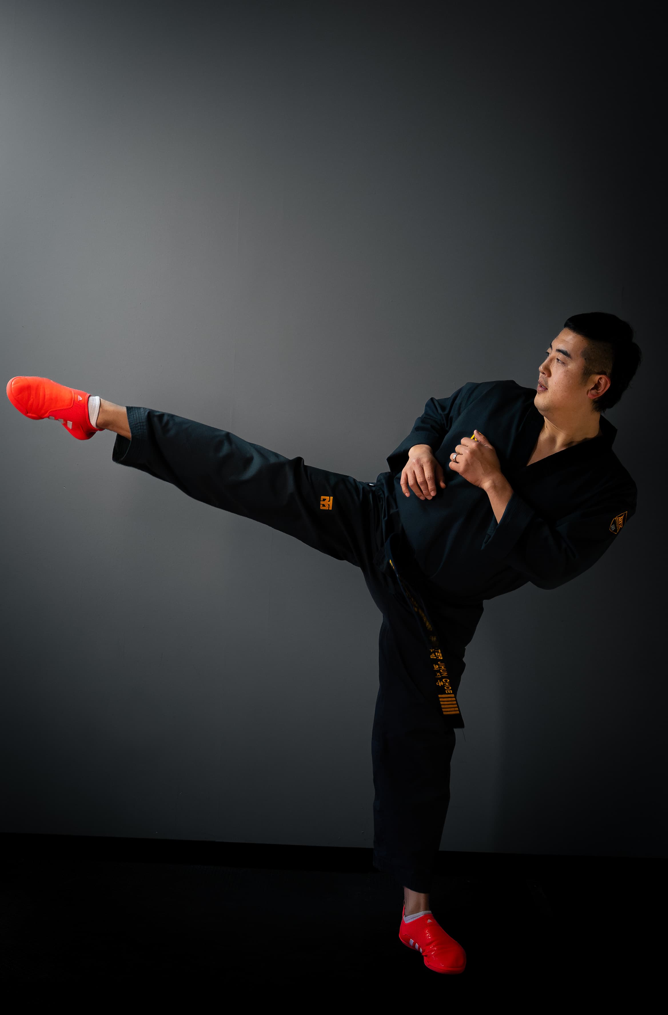 Master Choe throwing a side kick in a black dobok